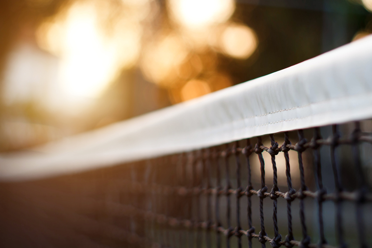 Tennis net with bokeh nature in the background